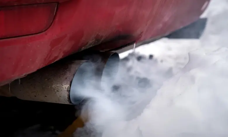 Car exhaust smoke in snow