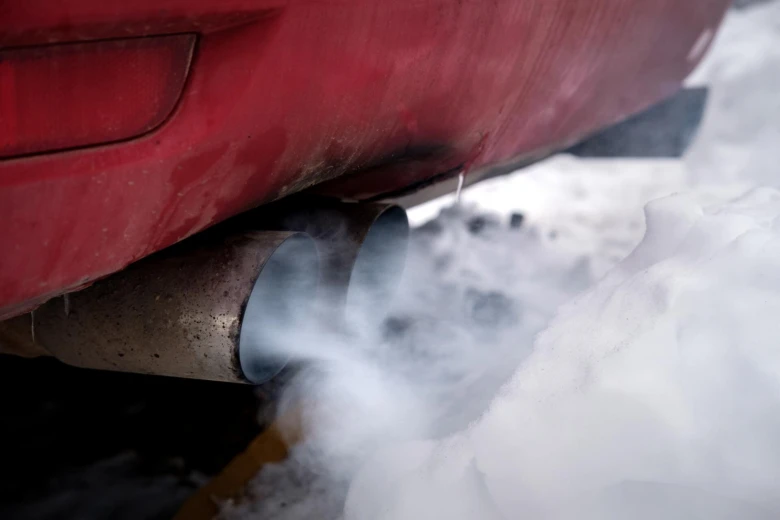 Car exhaust smoke in snow