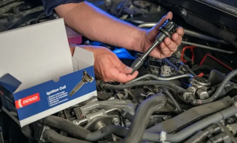 Mechanik montuje nový zapalovací cívku do motoru.