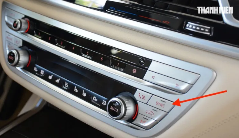 Detailní záběr na tlačítko Sync v ovládacím panelu automobilu.