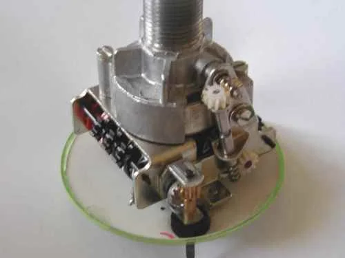 Vnitřní mechanismus rychloměru s ozubenými koly a součástkami.