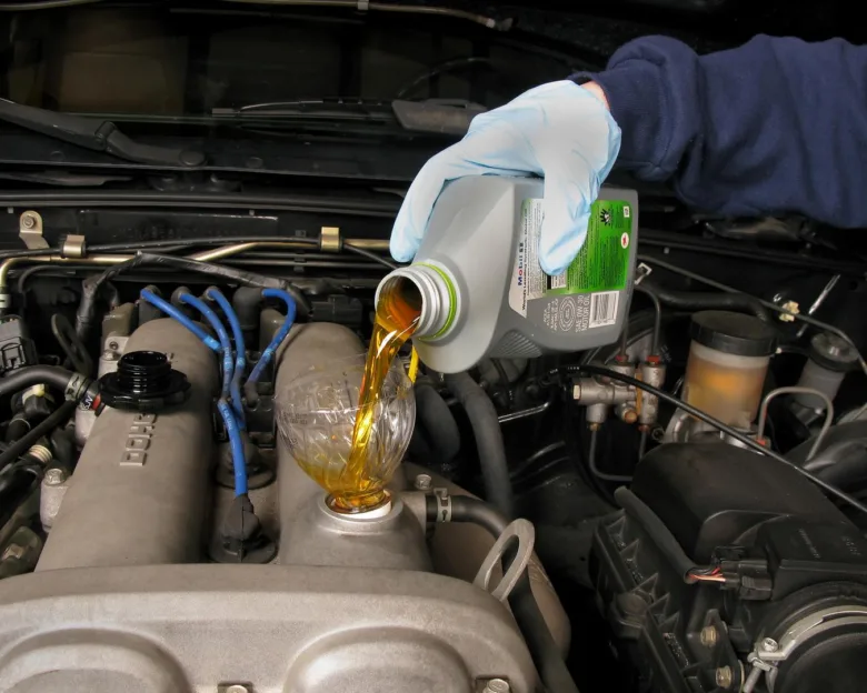 Pouring oil into engine