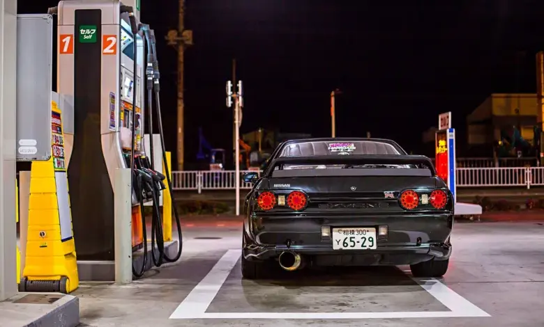 Černé auto u čerpací stanice v noci.