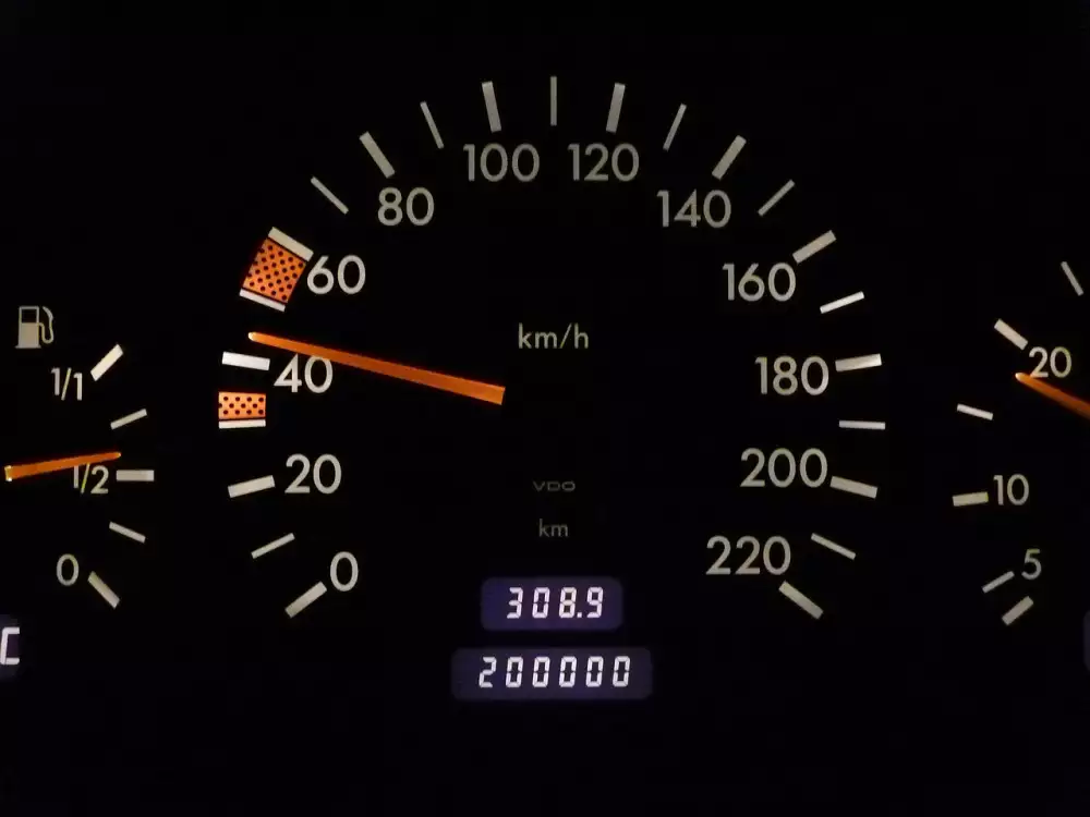 Přístrojová deska automobilu ukazující rychloměr s jehlou na čtyřiadvacet kilometrů za hodinu.
