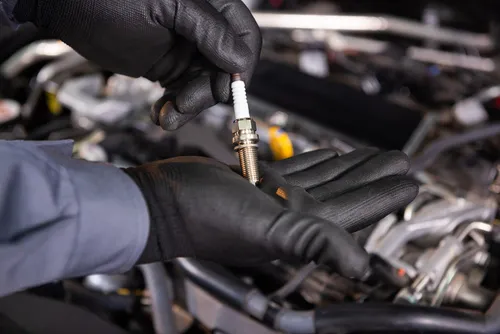 Mechanic holding spark plug