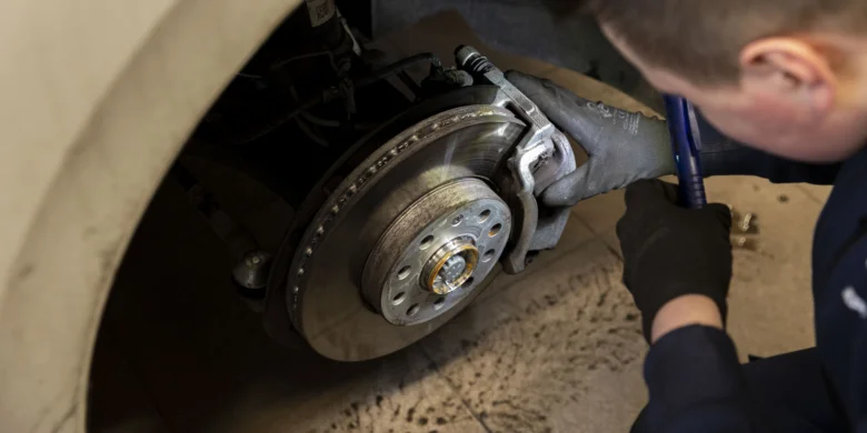 Mechanik opravuje bubnové brzdy u automobilu