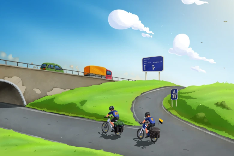 Dva cyklisté jedou po silnici pod mostem s auty a kamiony.