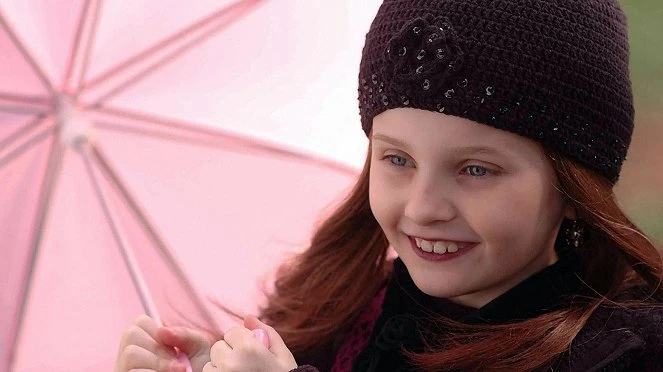 Smiling girl with pink umbrella