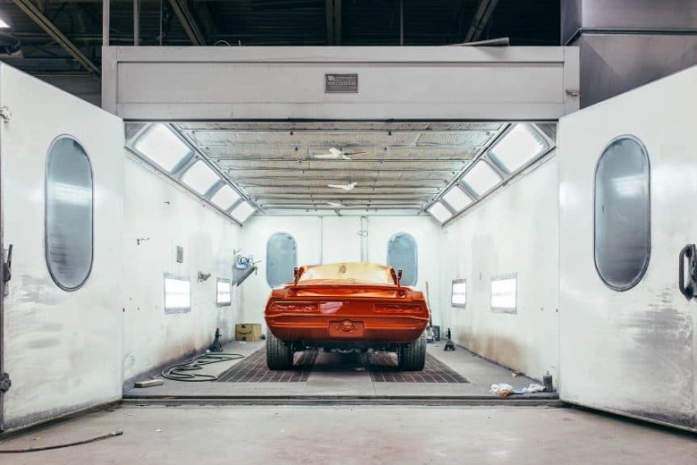 Orange car in paint booth