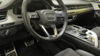 Interiér vozu s černým volantem značky Audi.